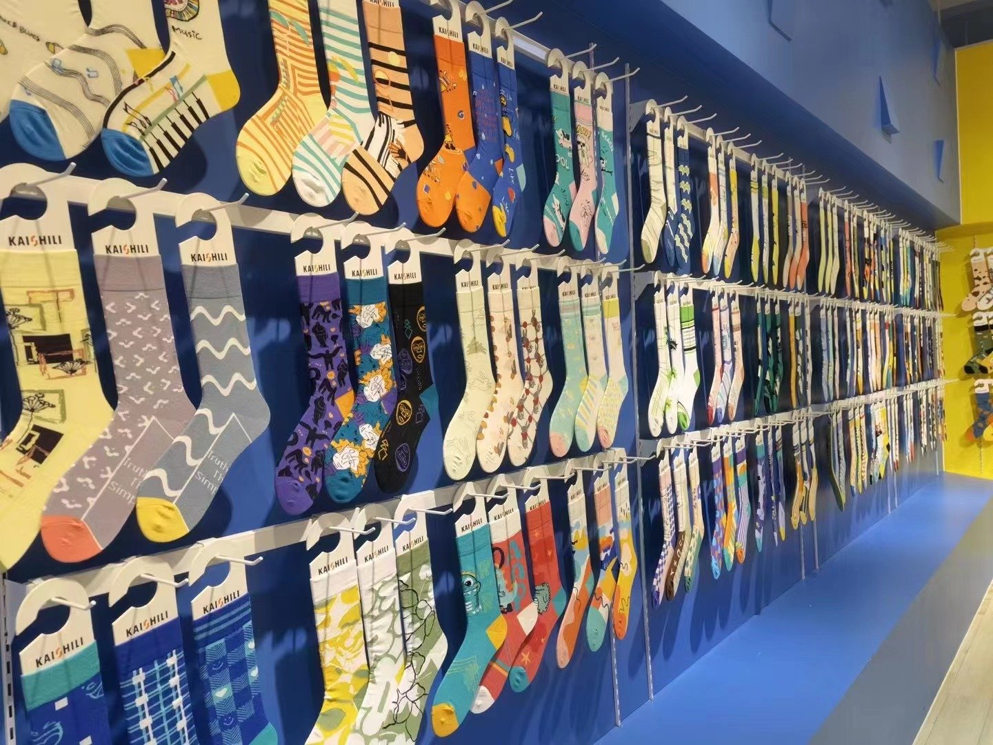 Wall of custom sock samples in different designs at the factory
